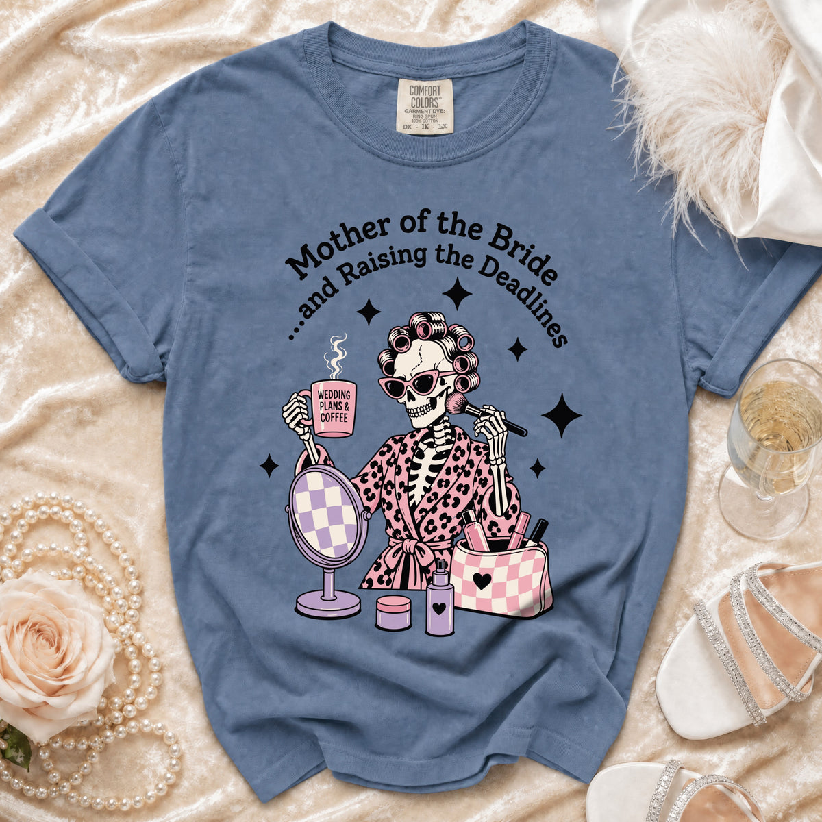 Blue Comfort Colors shirt with skeleton graphic: "Mother of the Bride...and Raising the Deadlines."