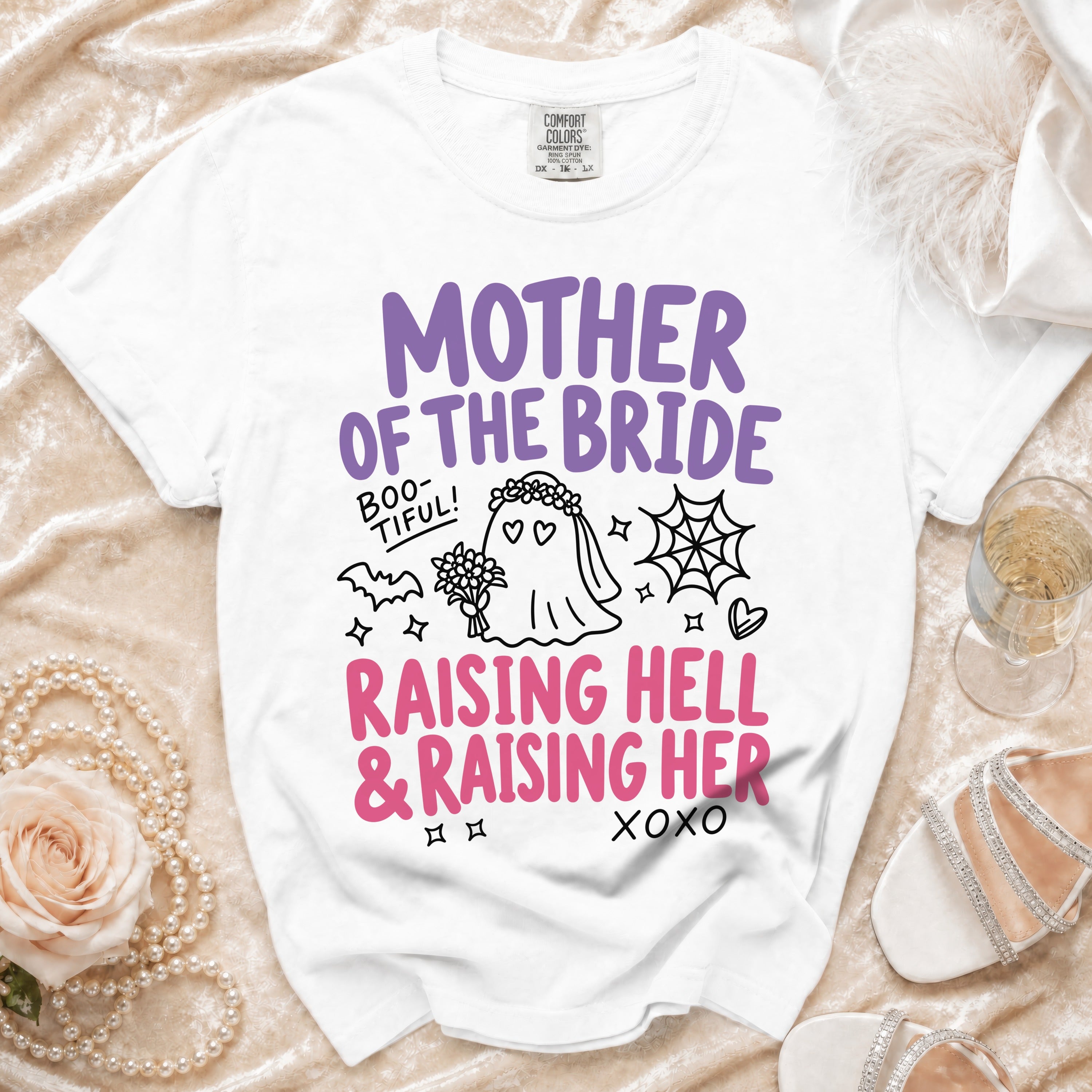 White t-shirt with "Mother of the Bride," "Boo-tiful!", and "Raising Hell & Raising Her" text.