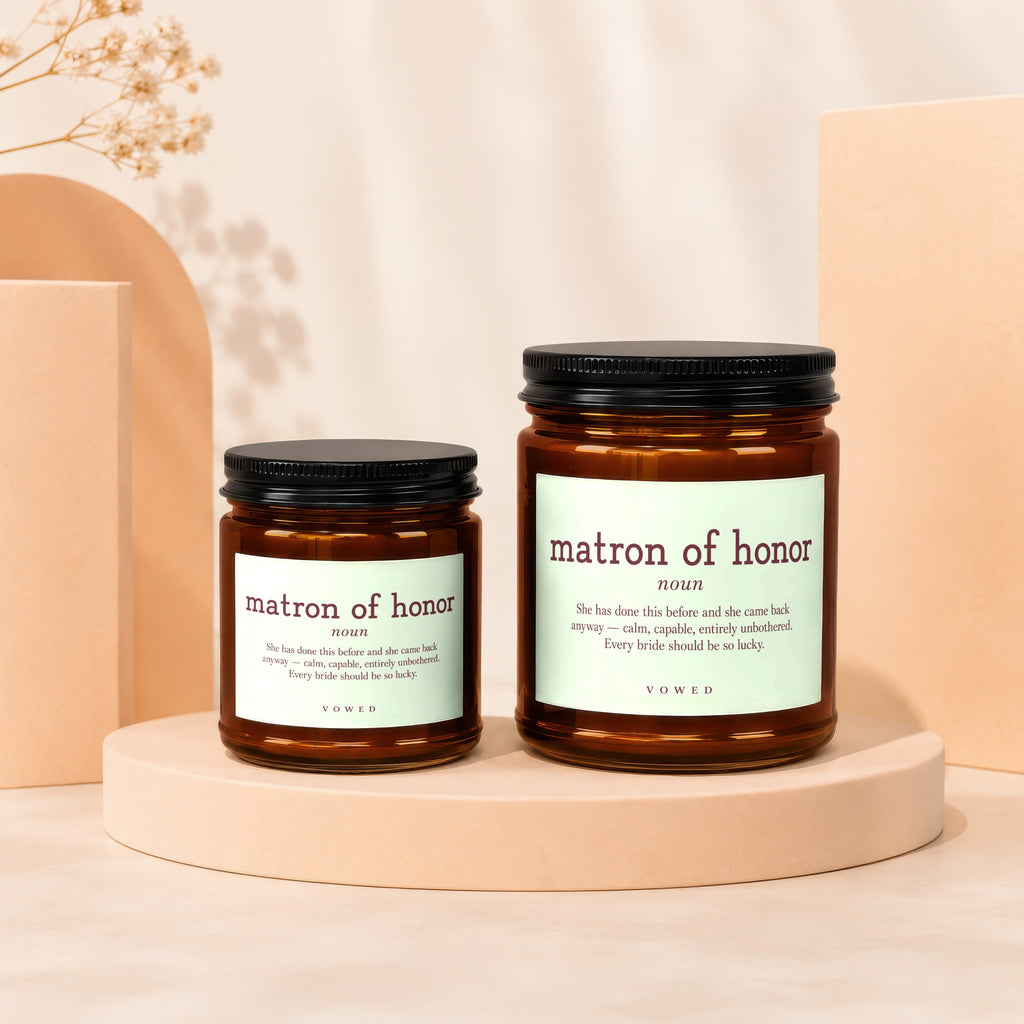 Two amber glass candles with "matron of honor" text and definition.