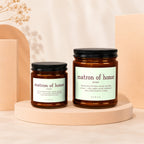 Two amber glass candles with "matron of honor" text and definition.