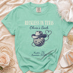 Mint green Comfort Colors t-shirt with "Reckless in Texas Olivia's Bach" design.