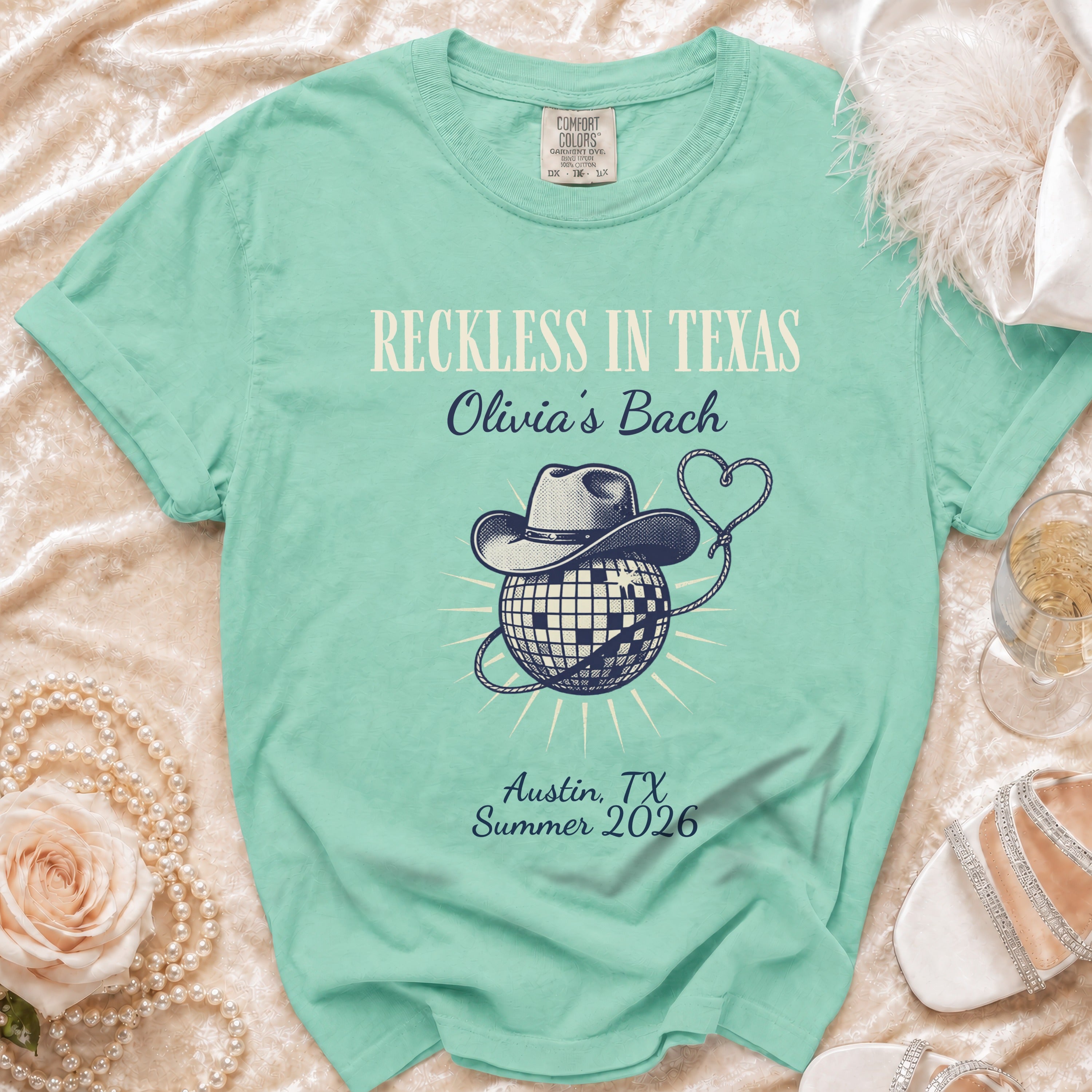 Mint green Comfort Colors t-shirt with "Reckless in Texas Olivia's Bach" design.