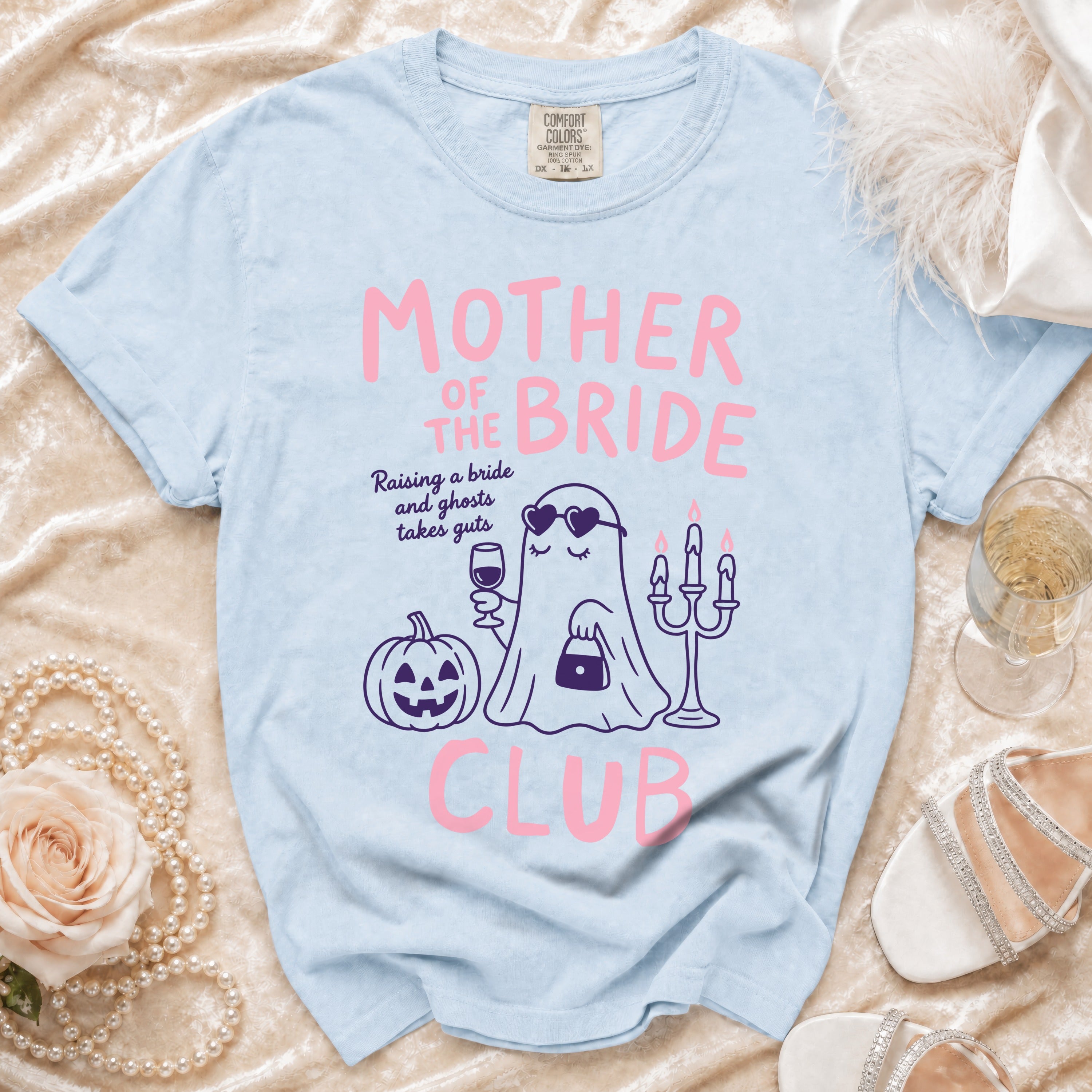 Light blue t-shirt with pink "Mother of the Bride Club" text and ghost graphic.