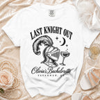 A white t-shirt features black text reading Last Knight Out above a knight's helmet and champagne glass graphic, with Olivia's Bachelorette Savannah, GA below.