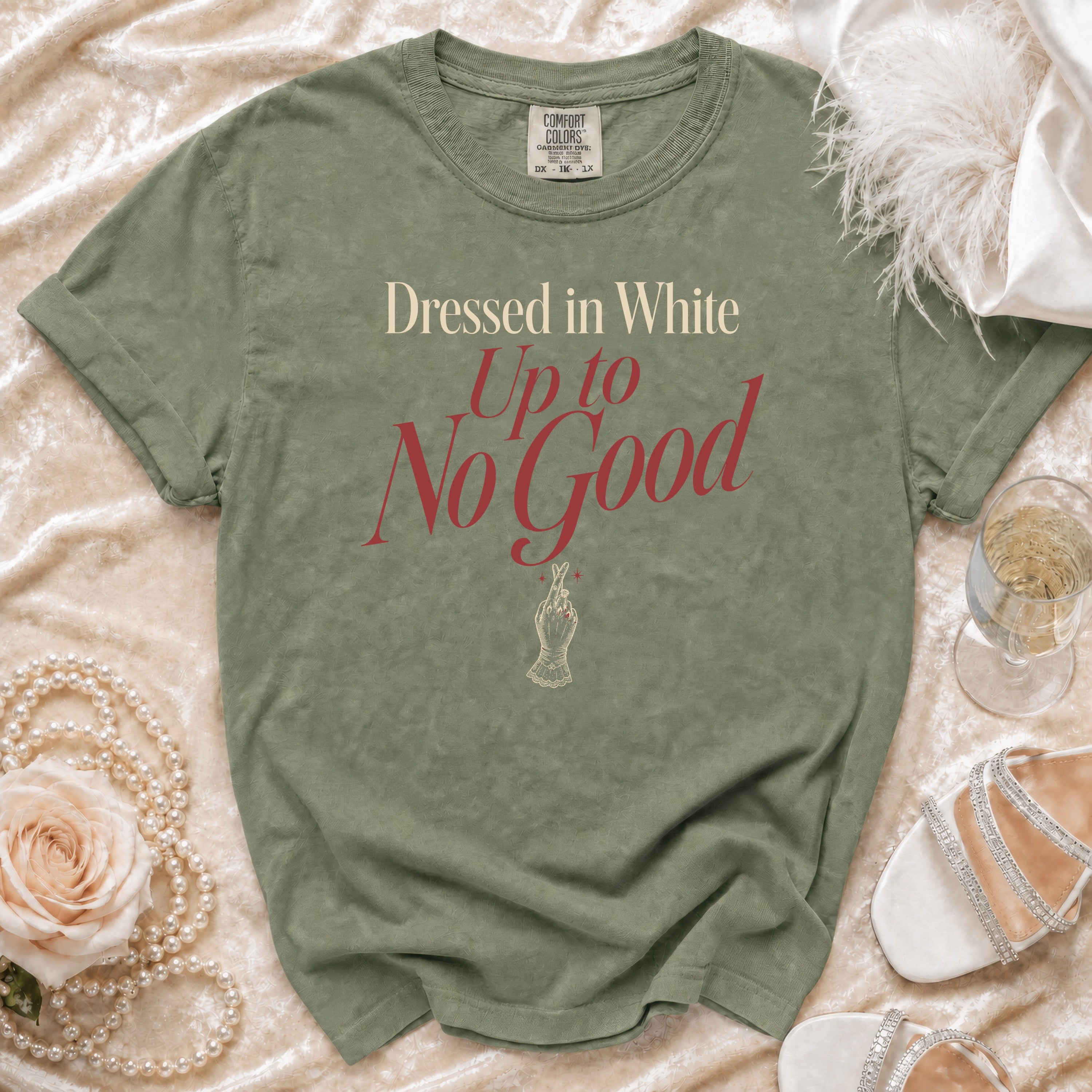 Olive green t-shirt with "Dressed in White Up to No Good" text and hand graphic.