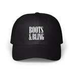 A black baseball cap with white embroidered text reading BOOTS & BLING centered on the front.