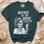 Dark teal t-shirt with a skeleton wearing a crown and holding champagne, reads "MOTHER OF THE BRIDE TO DIE FOR".