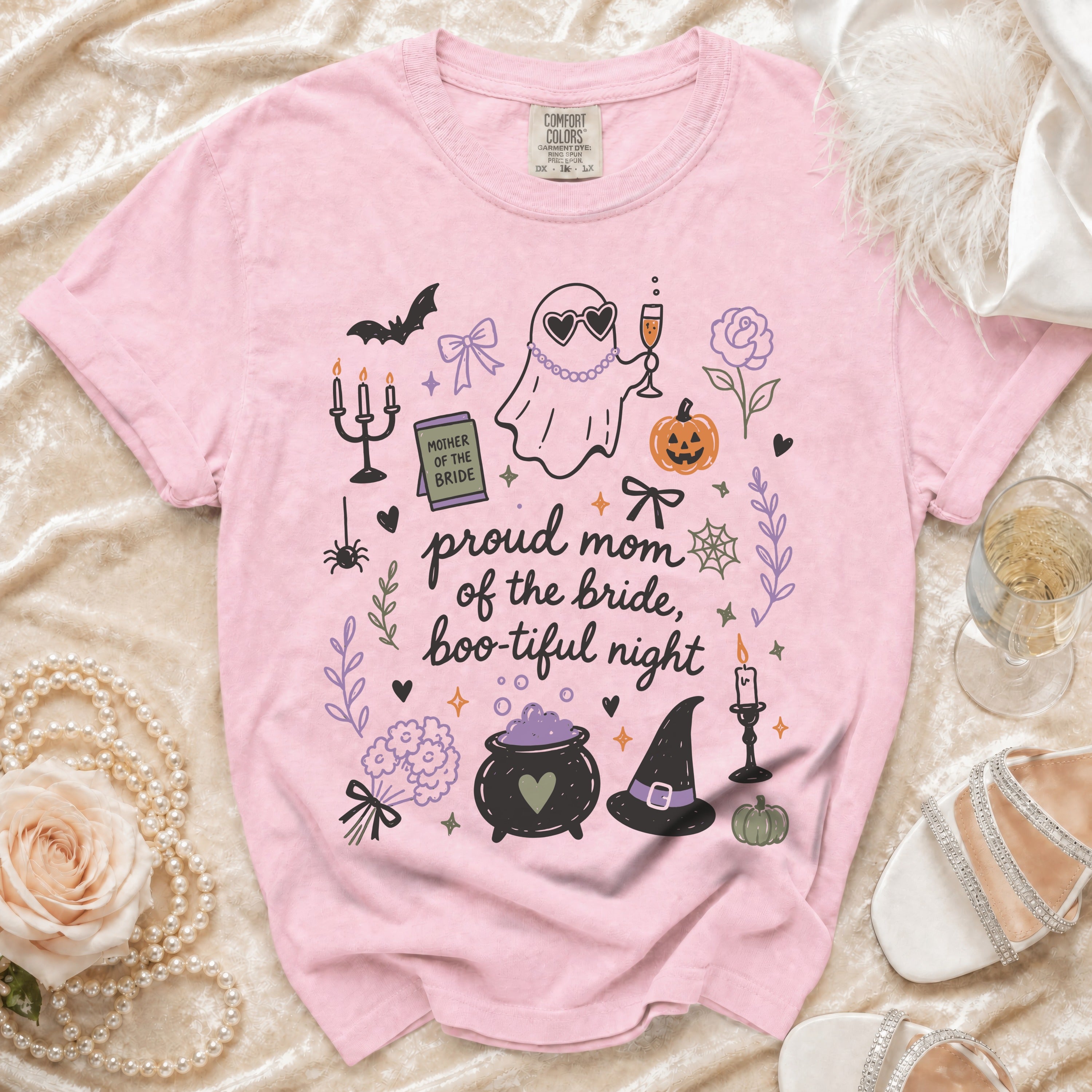 Pink t-shirt with "proud mom of the bride, boo-tiful night" graphic.