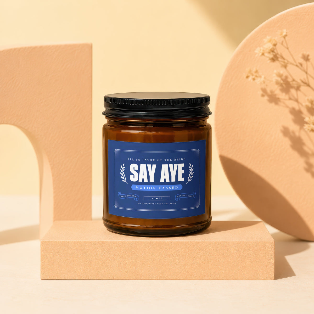 Brown candle with "Say Aye" label in navy blue, "Motion Passed," and "Vowed."