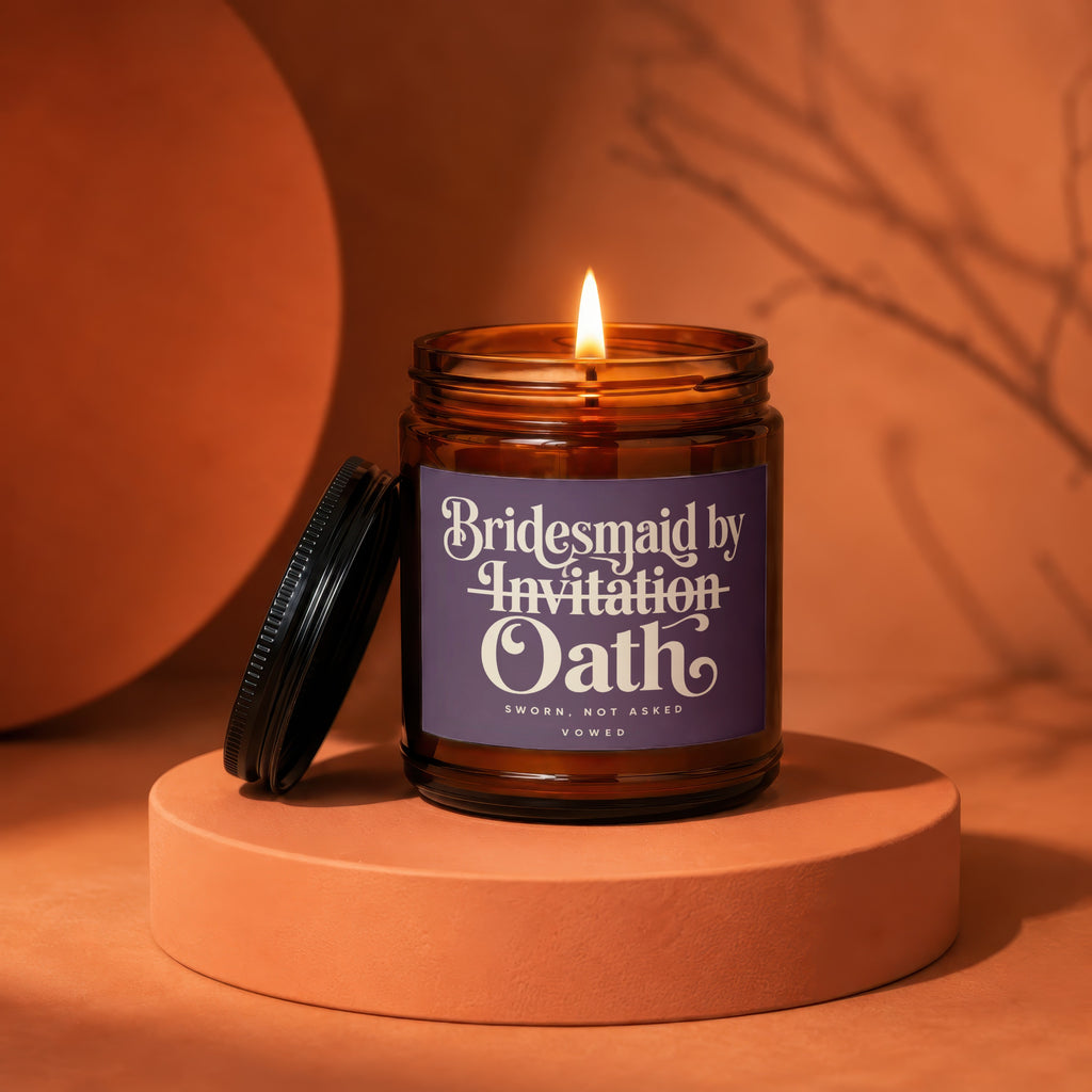 Amber glass candle with purple label that reads "Bridesmaid by Invitation Oath".