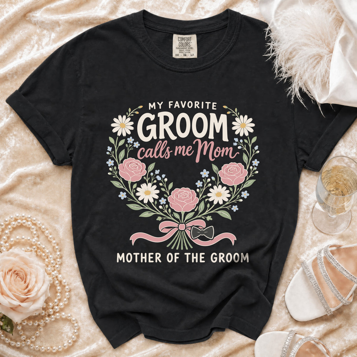 Black t-shirt with "My Favorite Groom calls me Mom, Mother of the Groom" text and floral design.