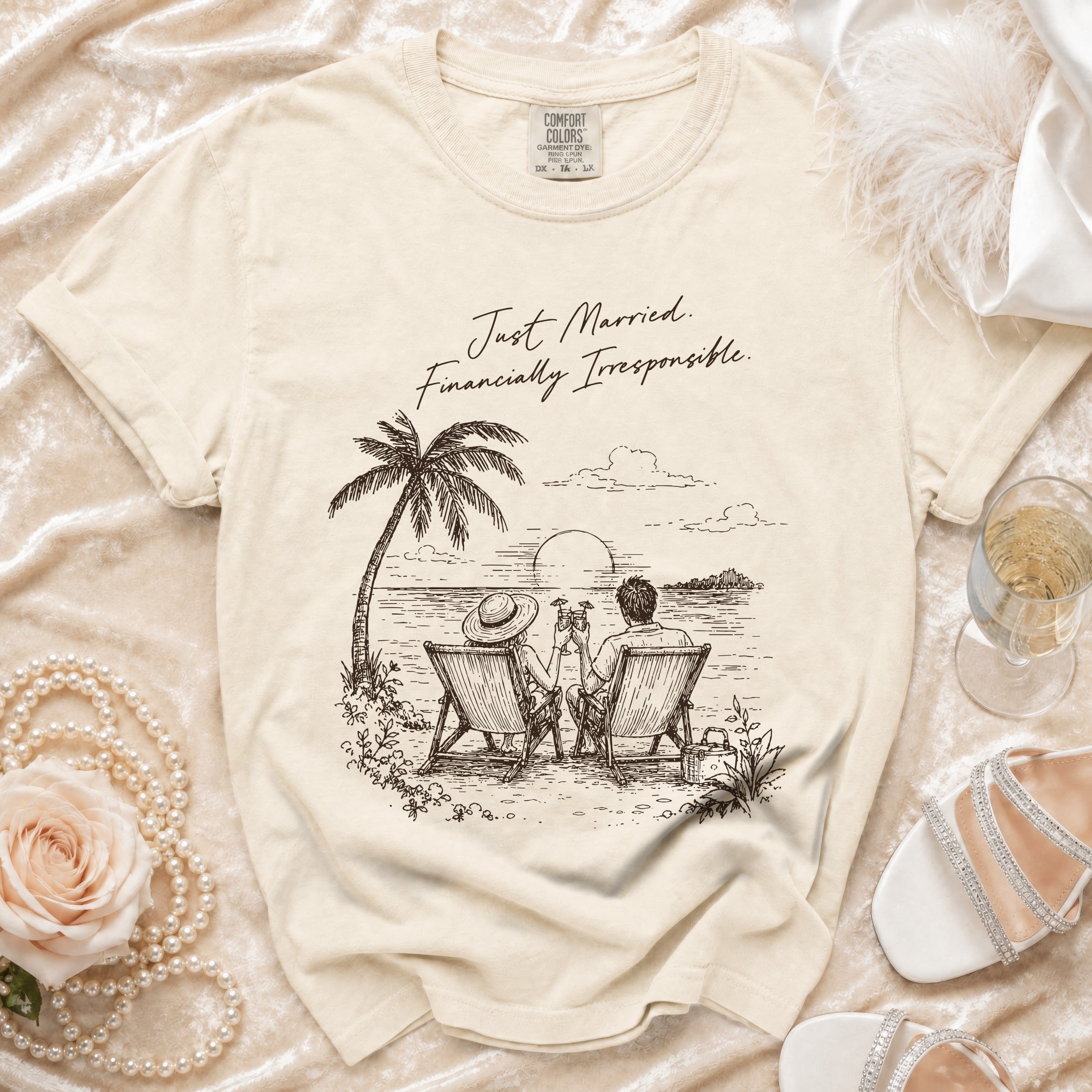 Cream t-shirt with "Just Married. Financially Irresponsible." and beach graphic for a couple.