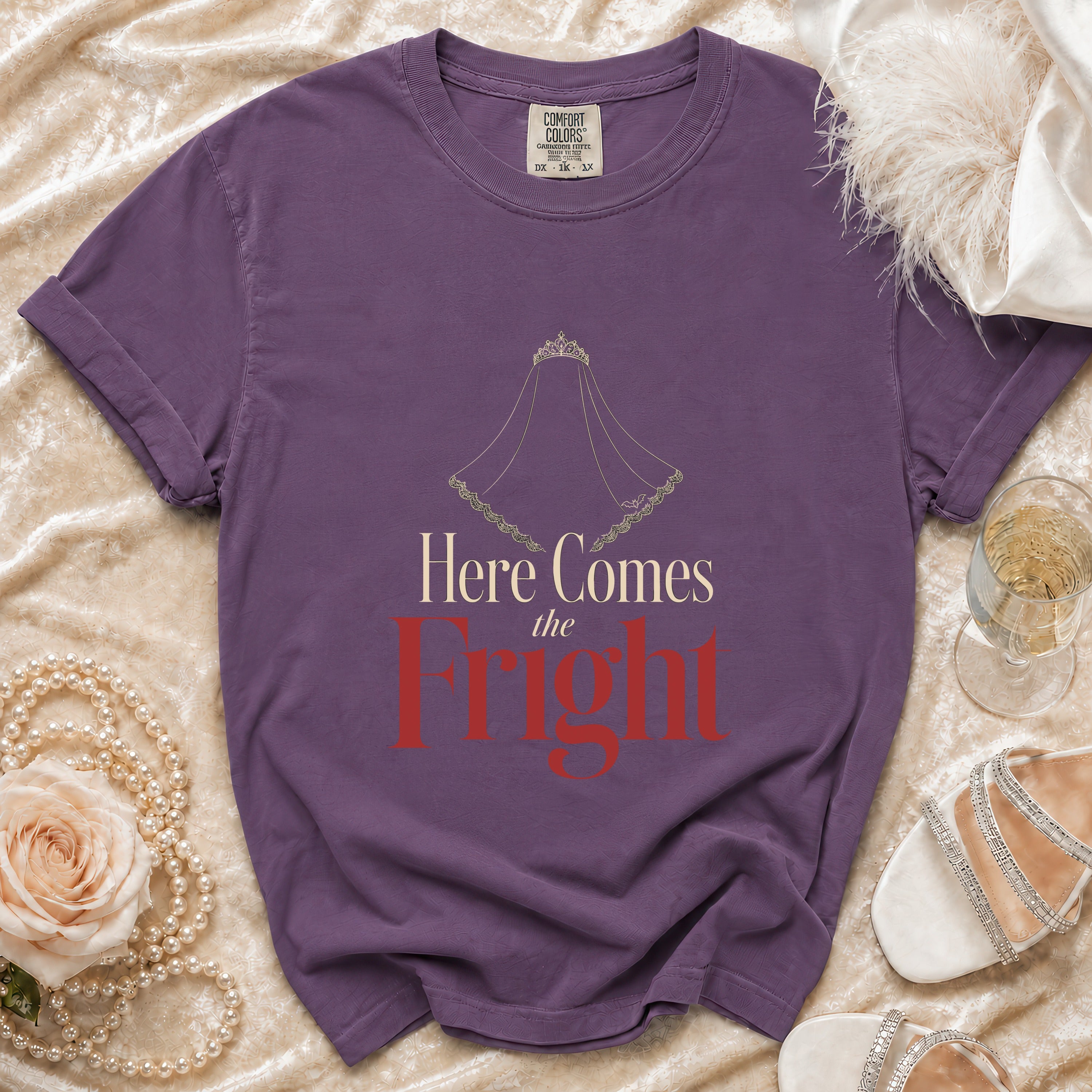 Purple t-shirt with a veil graphic and text "Here Comes the Fright".