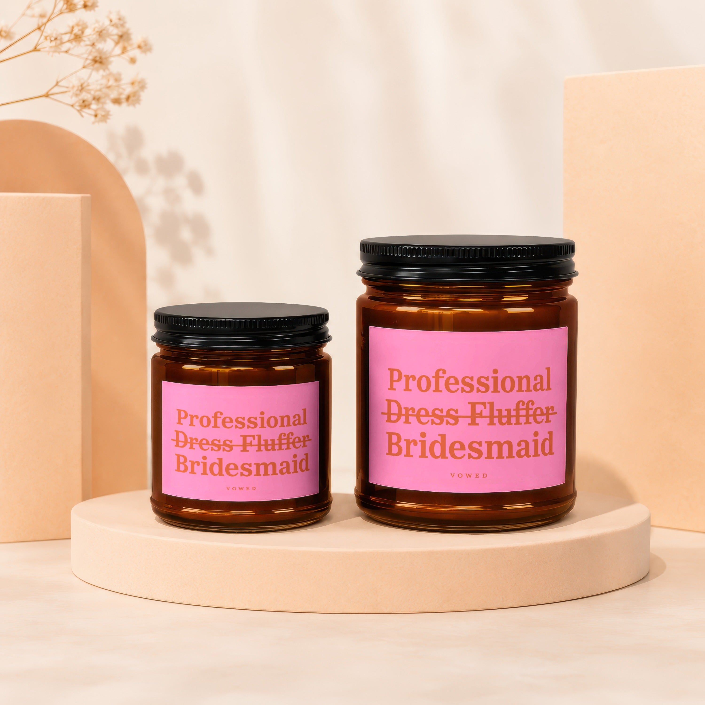 Two amber jars with black lids and pink labels reading "Professional Dress Fluffer Bridesmaid."