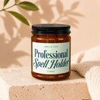 Amber jar candle labeled "Smells Like Professional Spell Holder" by Vowed.