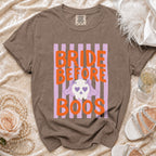 Brown t-shirt with orange text "BRIDE BEFORE BOOS" and a ghost graphic.