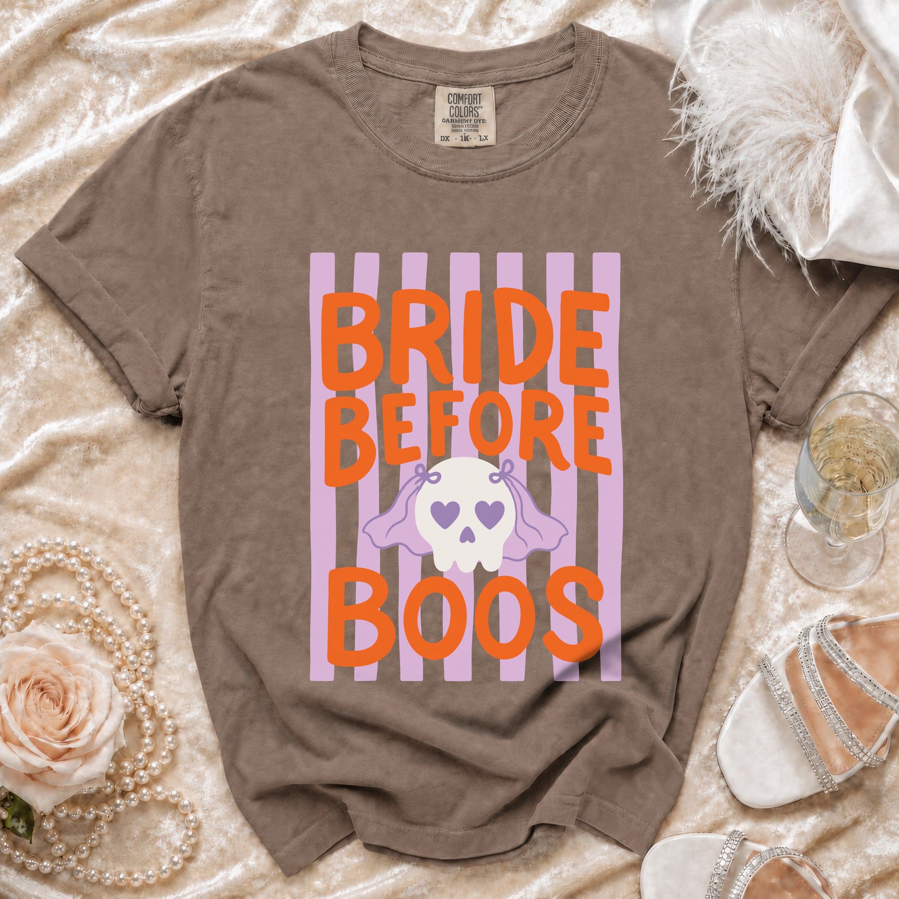 Brown t-shirt with orange text "BRIDE BEFORE BOOS" and a ghost graphic.