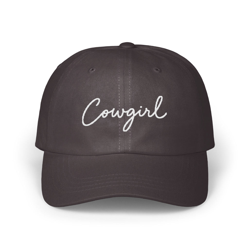 Dark gray baseball cap featuring the word Cowgirl embroidered in white cursive script across the front.