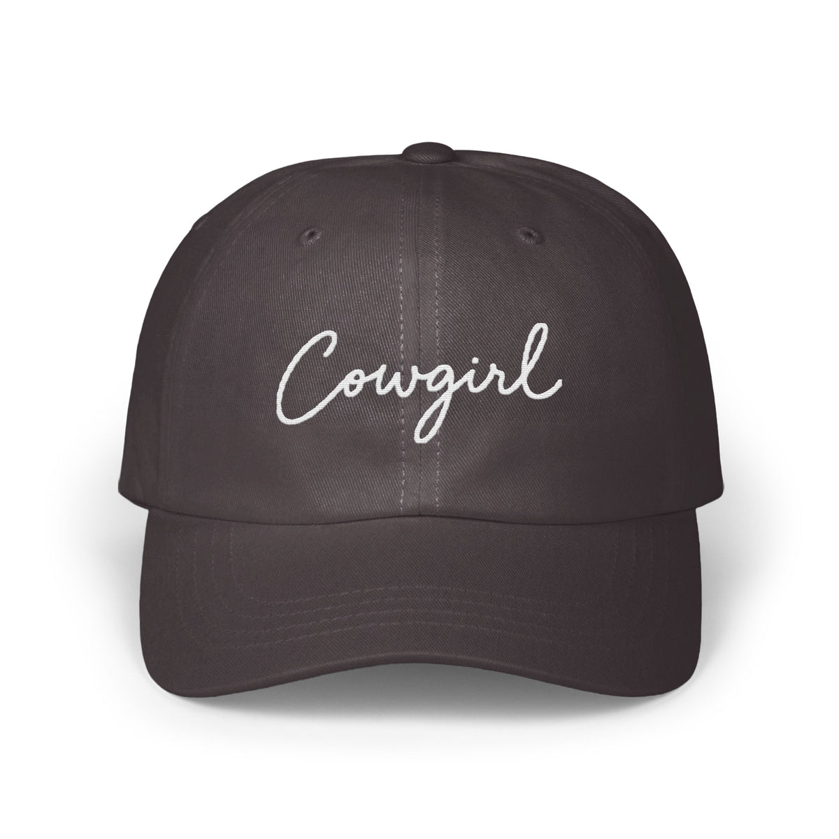 Dark gray baseball cap featuring the word Cowgirl embroidered in white cursive script across the front.