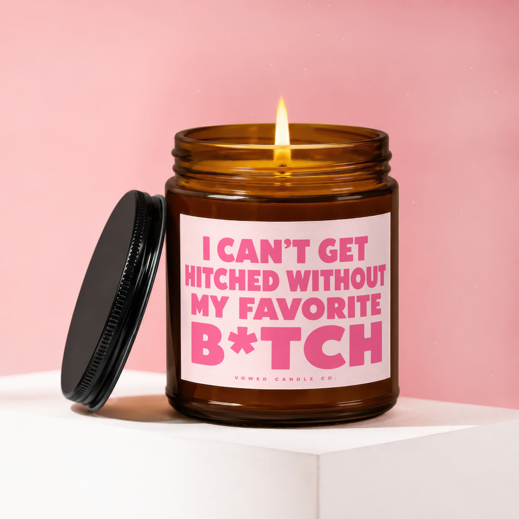 A lit candle in a brown jar with lid nearby, text reads "I CAN'T GET HITCHED WITHOUT MY FAVORITE B*TCH".