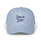 Light blue baseball cap with the embroidered dark blue text Snow in Love on the front.