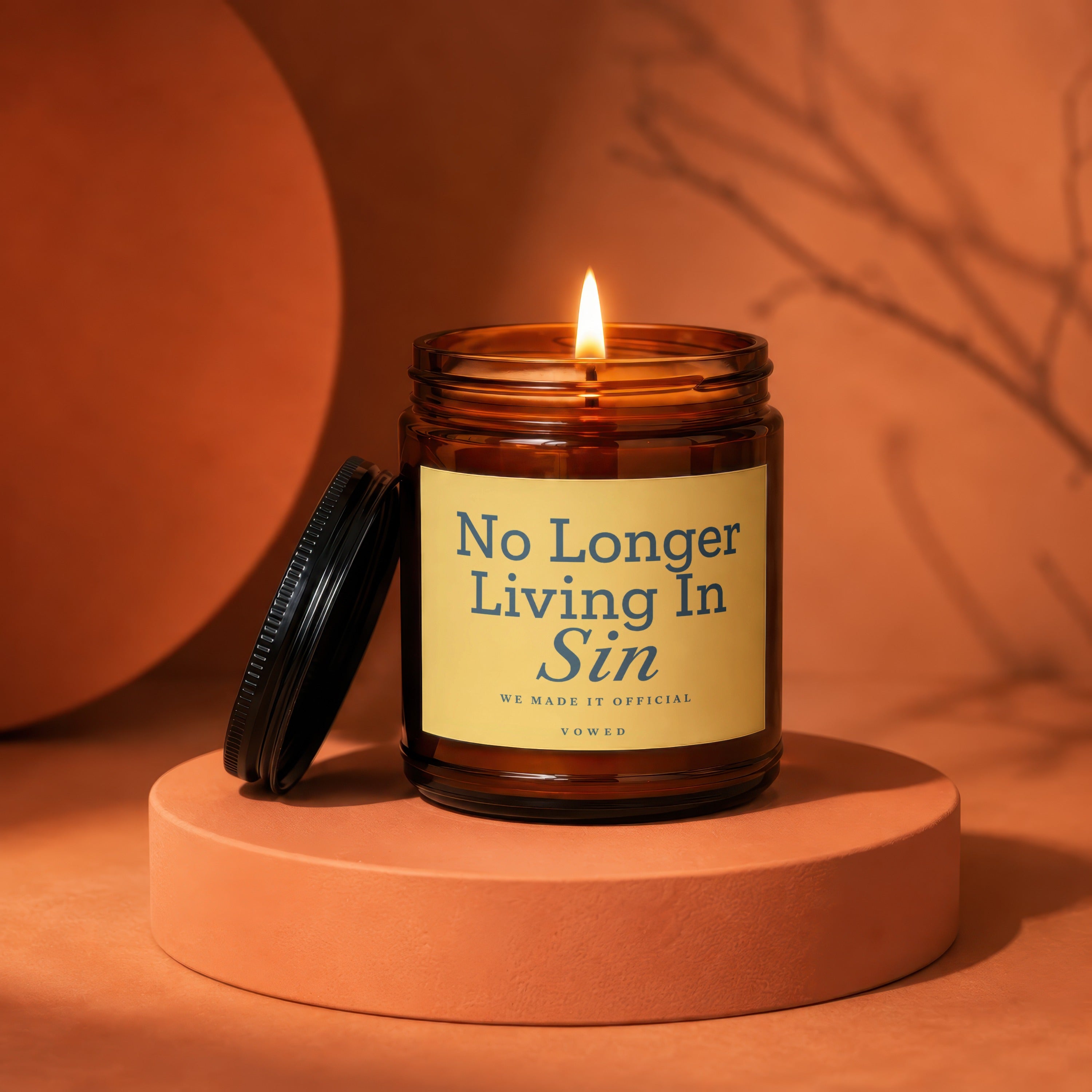 Brown glass candle with lit flame, and text "No Longer Living In Sin".