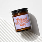 Candle with black lid and purple label reading "Love has no exceptions here, VOTED".