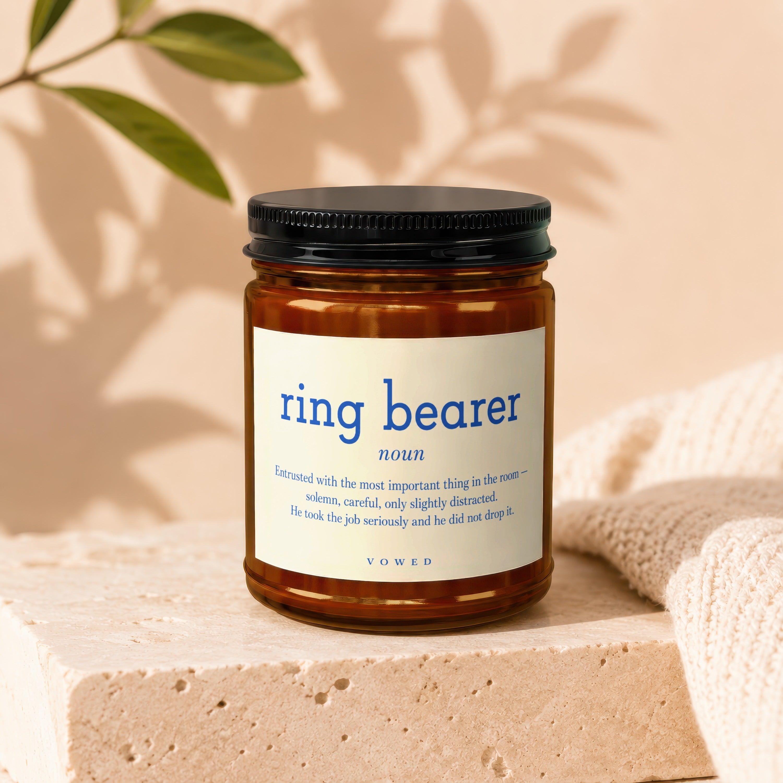 Brown glass candle labeled "ring bearer noun" with descriptive text.