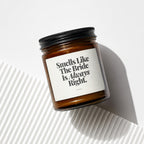 Amber candle in a glass jar with black lid, text "Smells Like The Bride Is Always Right."