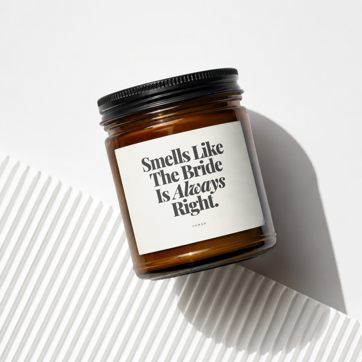 Amber candle in a glass jar with black lid, text "Smells Like The Bride Is Always Right."