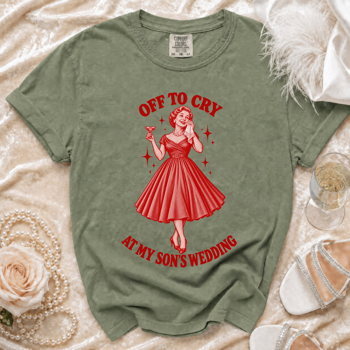Green t-shirt with red graphic "Off to Cry At My Son's Wedding" and retro woman.