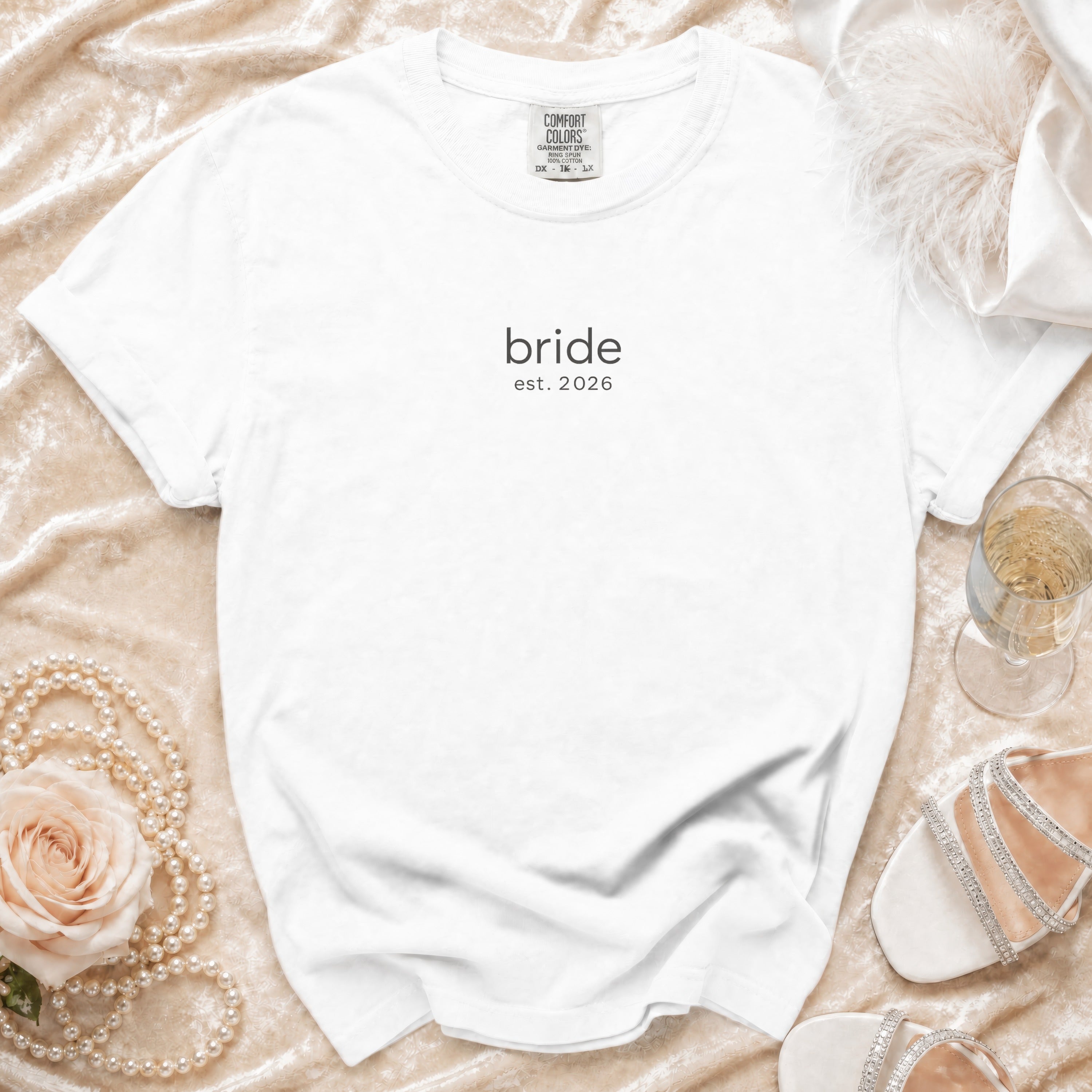 White t-shirt with "bride est. 2026" printed on it.