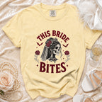 Light yellow t-shirt with "This Bride Bites" skull graphic and wedding details.