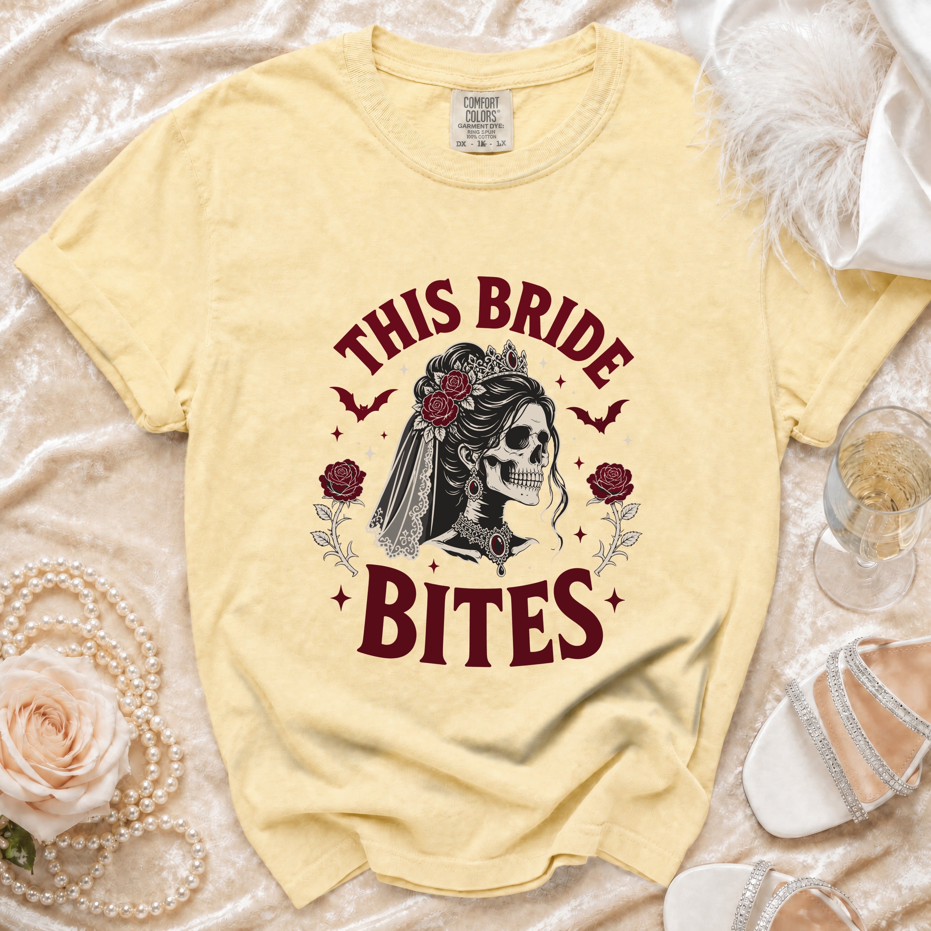 Light yellow t-shirt with "This Bride Bites" skull graphic and wedding details.