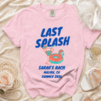 Pink t-shirt with "LAST SPLASH" text, cocktail, and ring float.