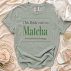 Sage green t-shirt with "This Bride runs on Matcha and unbothered energy" text.