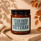 Amber candle in glass jar with "Team Bride Recruit Veteran Vowed" label.