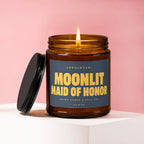 Amber candle with lit flame, dark blue label reads "Moonlit Maid of Honor".
