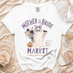 White t-shirt with "Mother of the Bride Market" graphic featuring a ghost, pumpkin, and flowers.