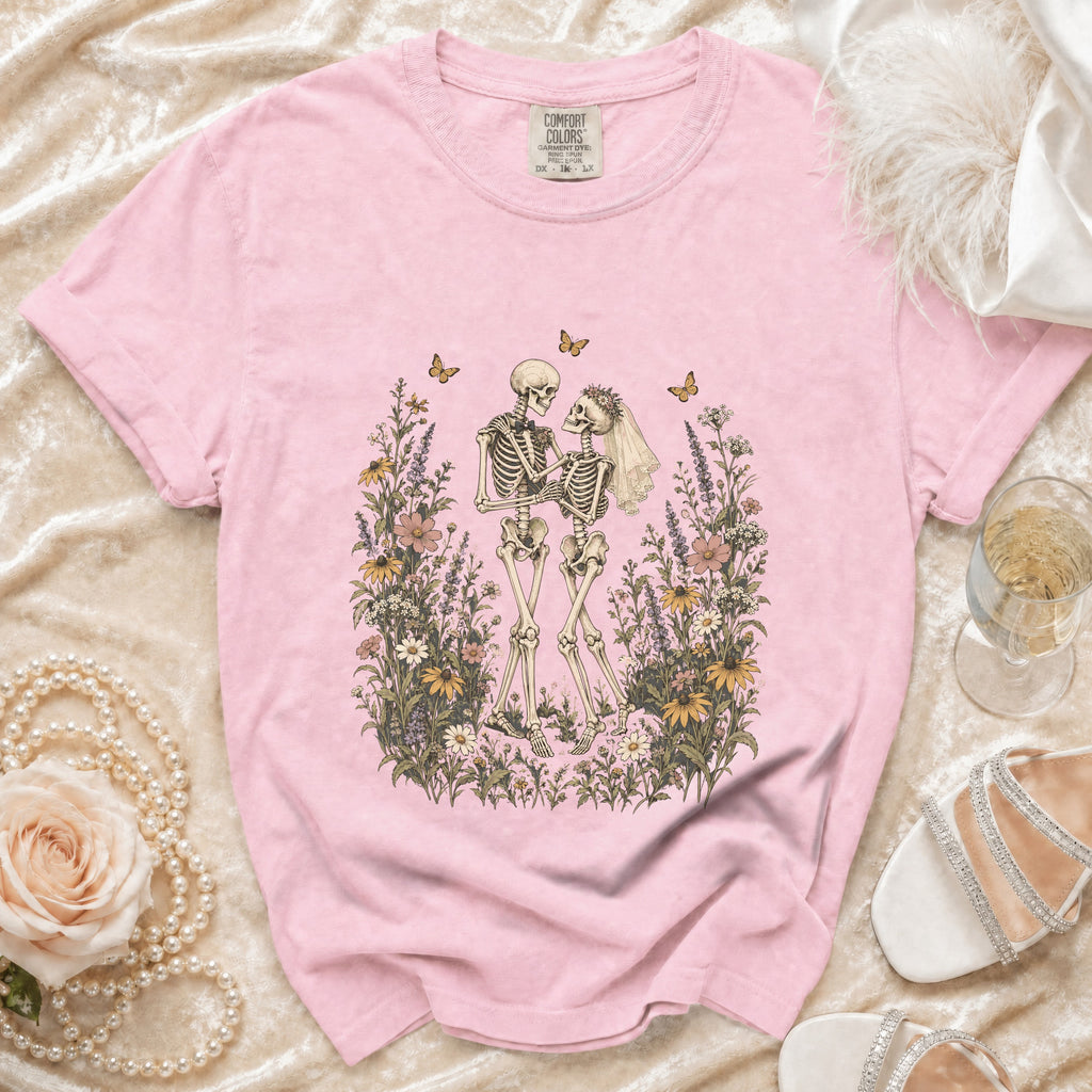 Pink t-shirt with a wedding skeleton couple illustration and Comfort Colors tag.