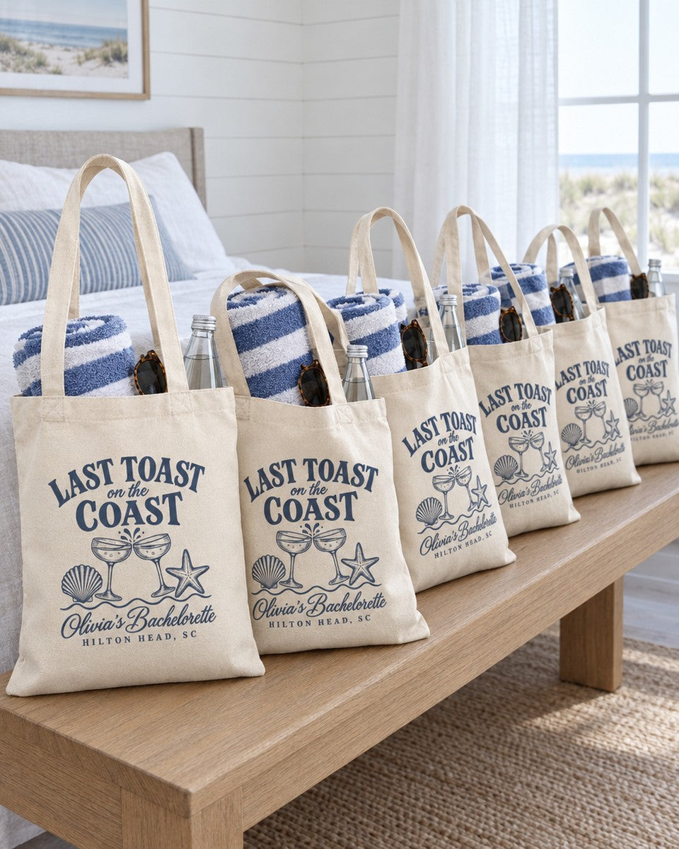Six Last Toast On The Coast canvas totes set out as welcome bags for a bachelorette group