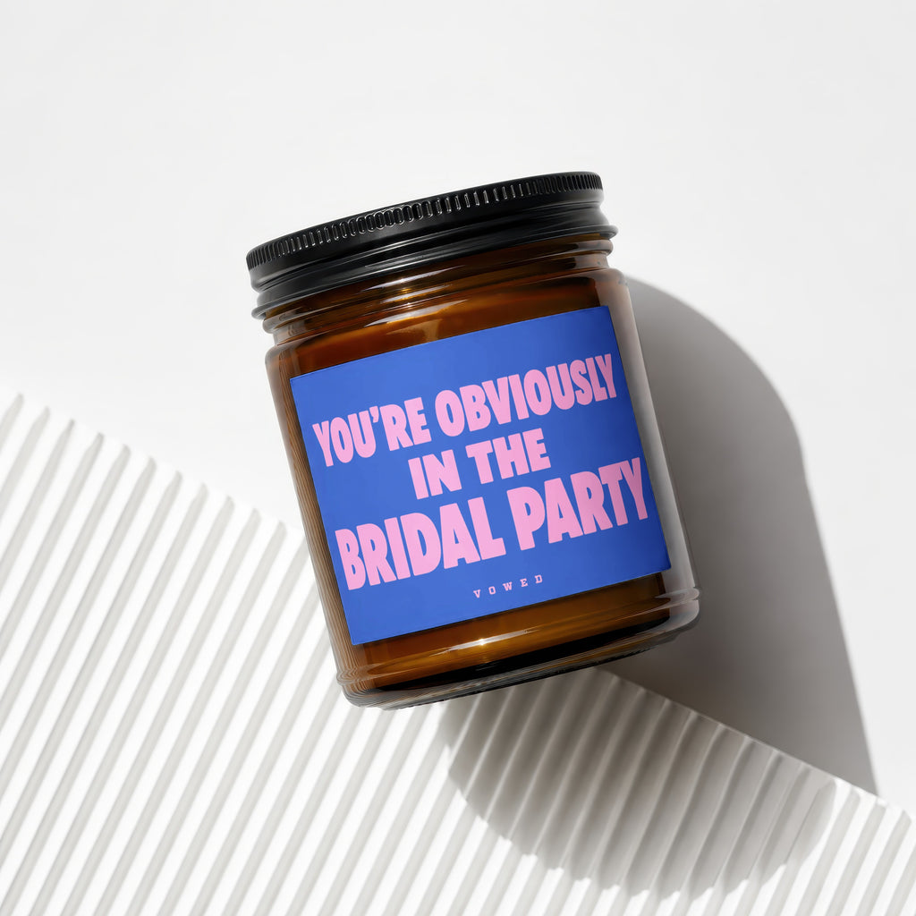 Brown candle in a jar with a blue label reading "YOU'RE OBVIOUSLY IN THE BRIDAL PARTY".