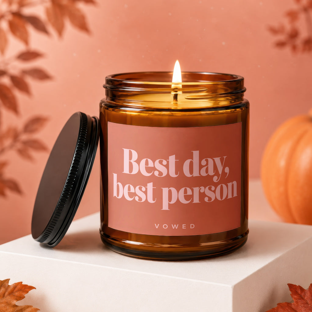 Amber candle with lit wick and lid off, reading "Best day, best person."