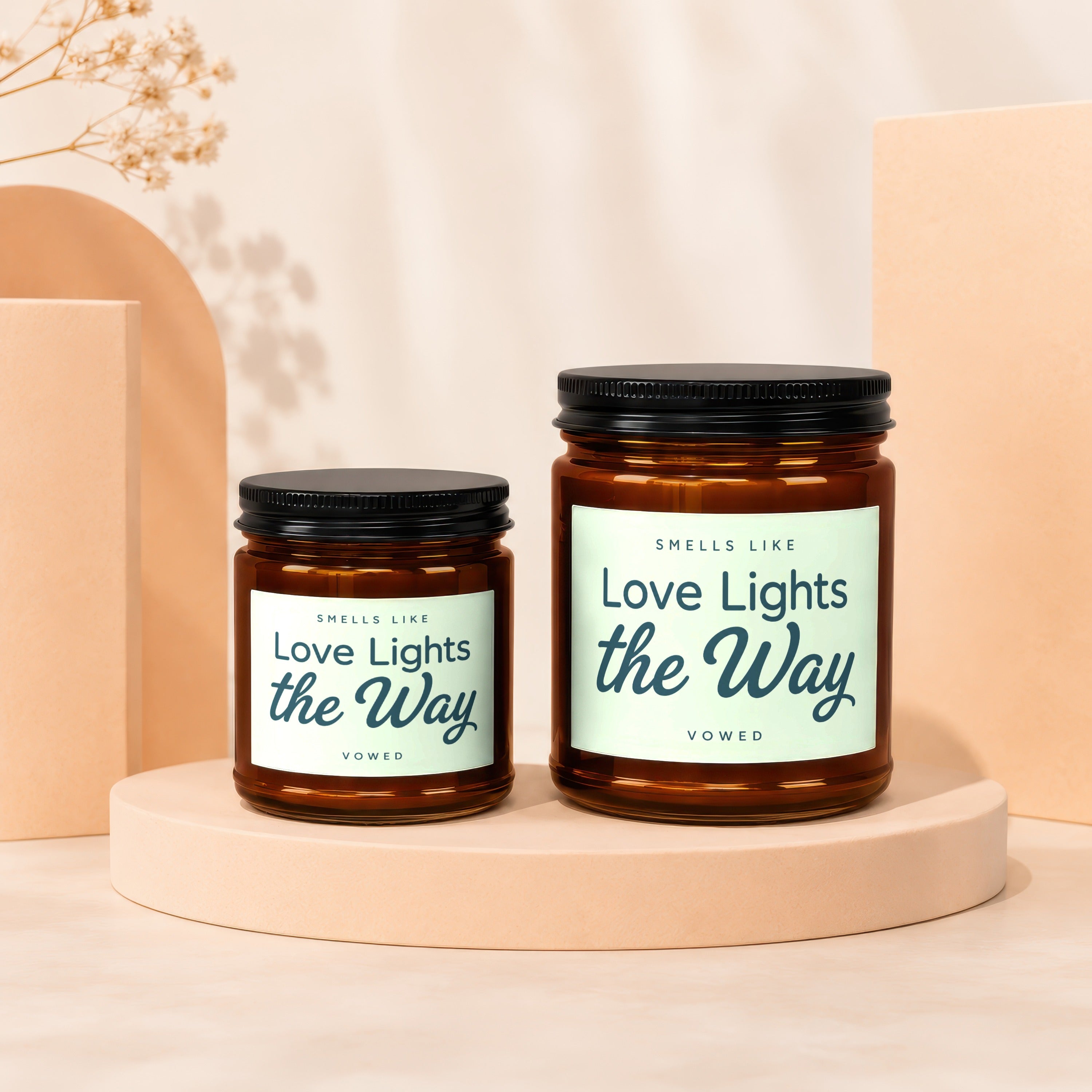 Two amber glass jars with black lids, each labeled "Love Lights the Way."