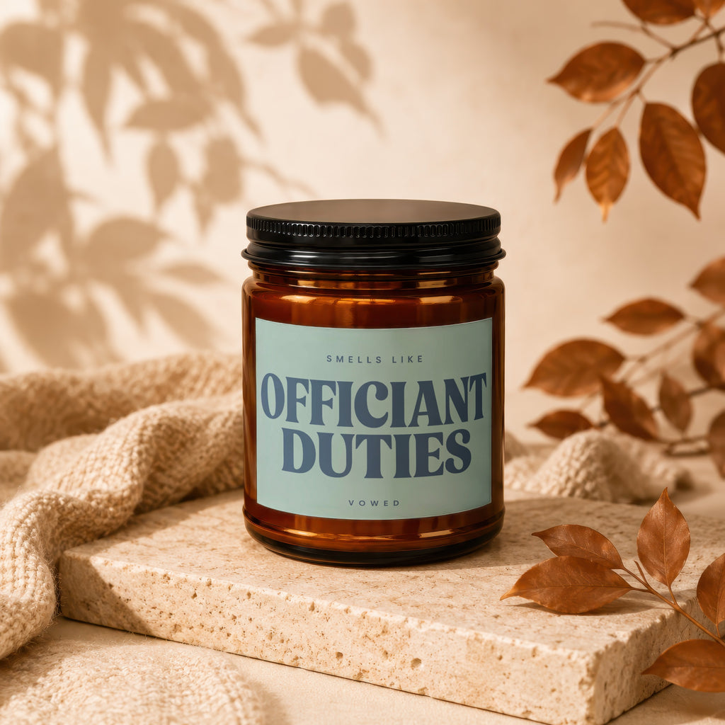 Amber candle in a jar with a black lid, labeled "Officant Duties".