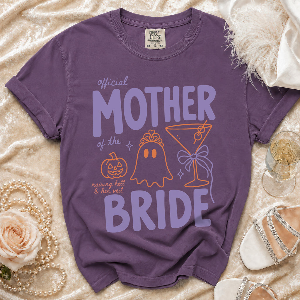 Purple Comfort Colors t-shirt with "Official Mother of the Bride" text and Halloween graphics.
