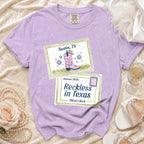 Purple t-shirt with "Austin, TX", "Summer 2026", and "Reckless in Texas" text.