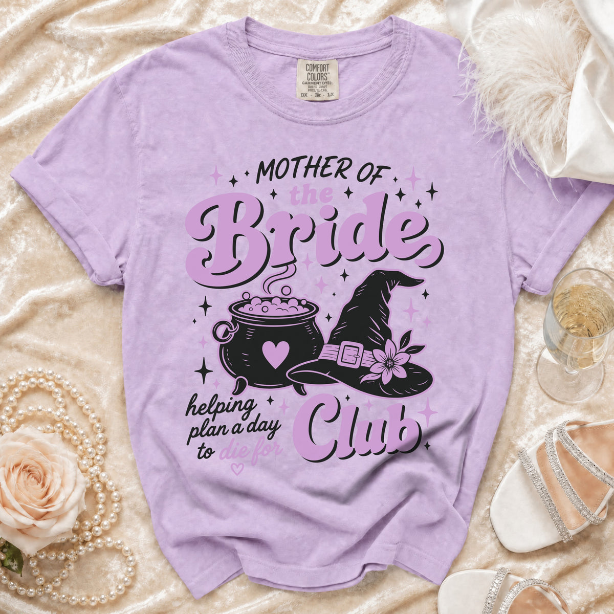 Purple t-shirt with "Mother of the Bride Club" text and witchy graphics.