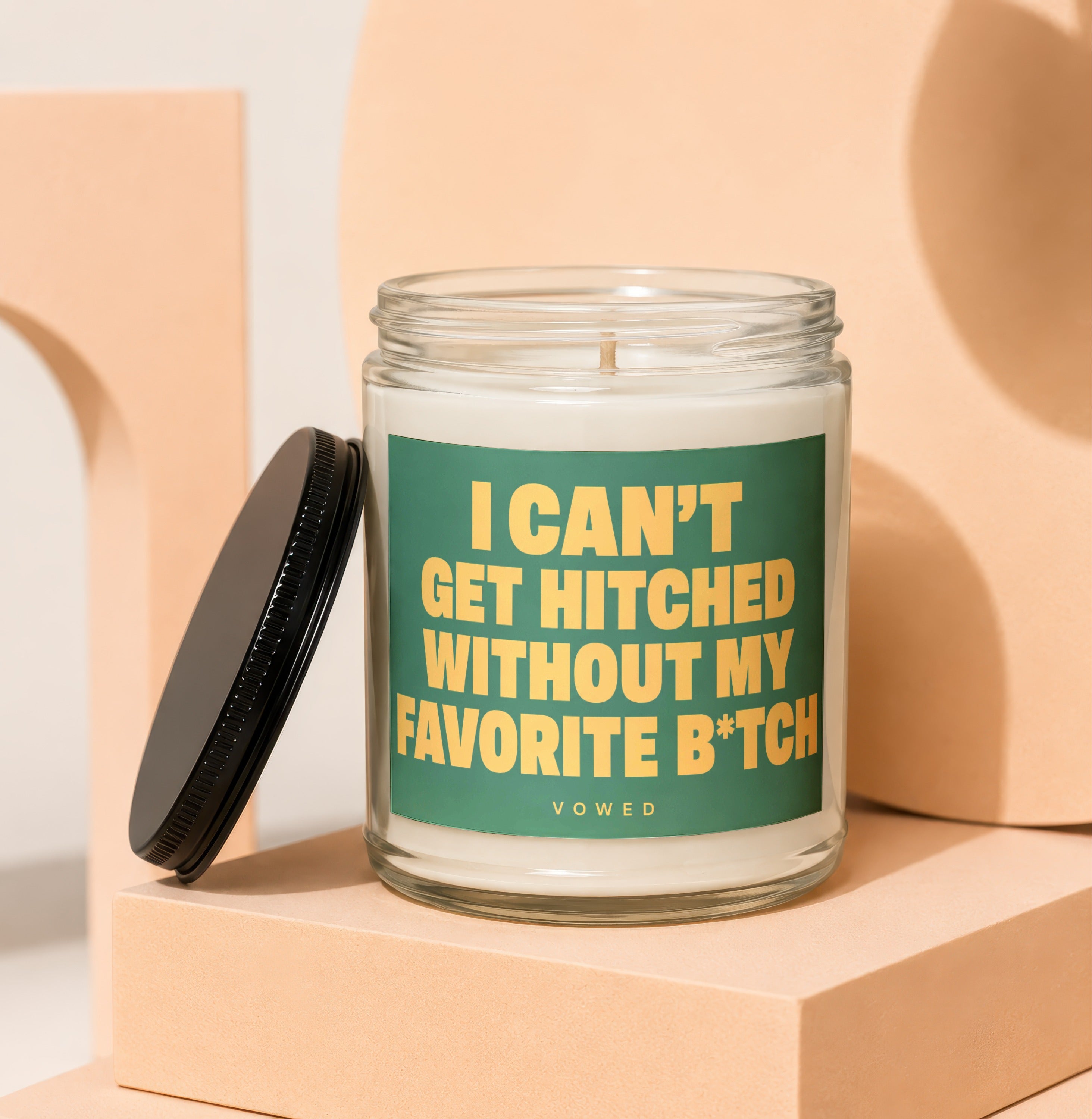 Glass jar candle with green label reading "I CAN'T GET HITCHED WITHOUT MY FAVORITE B*TCH".