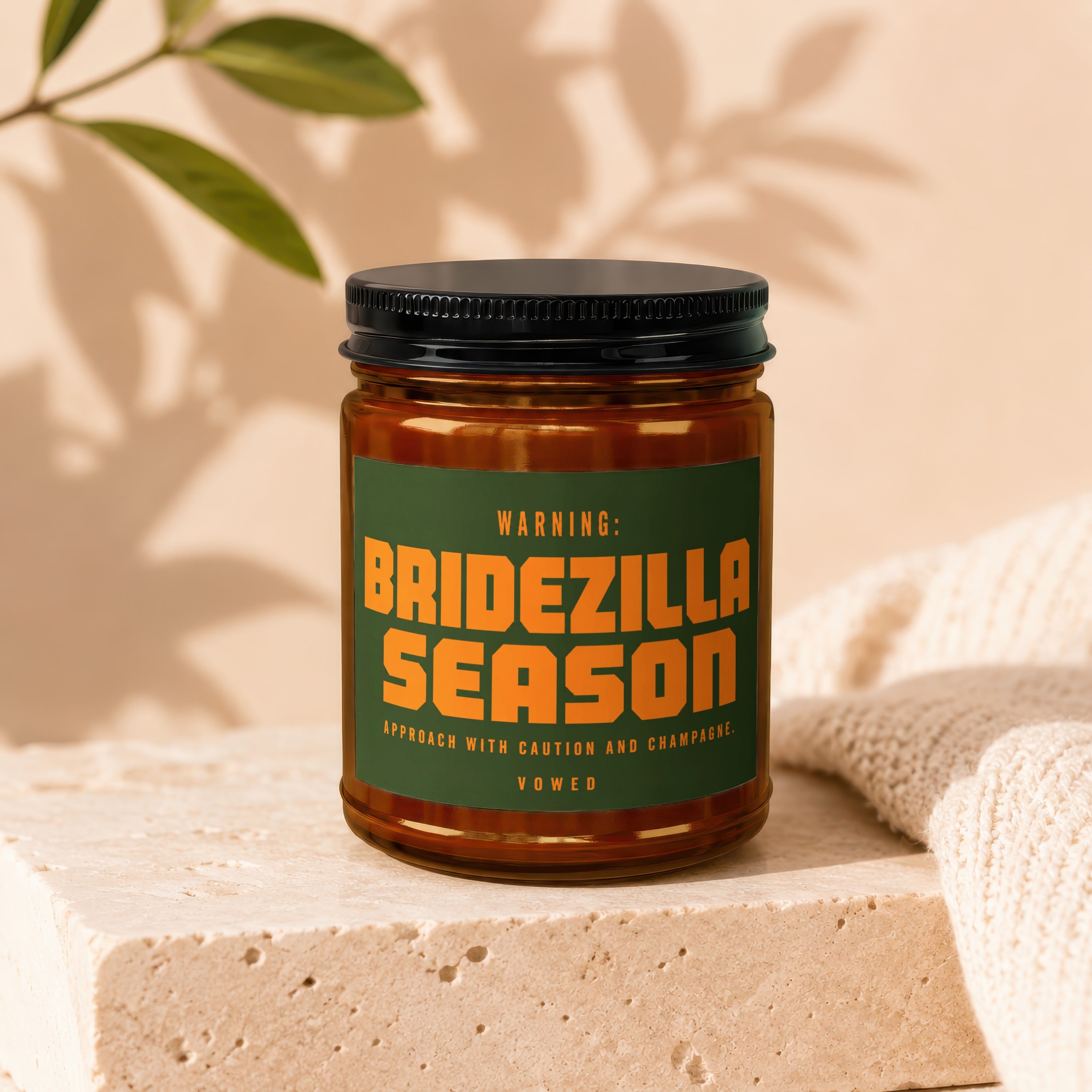 Amber jar candle with "BRIDEZILLA SEASON" warning label, "VOWED."